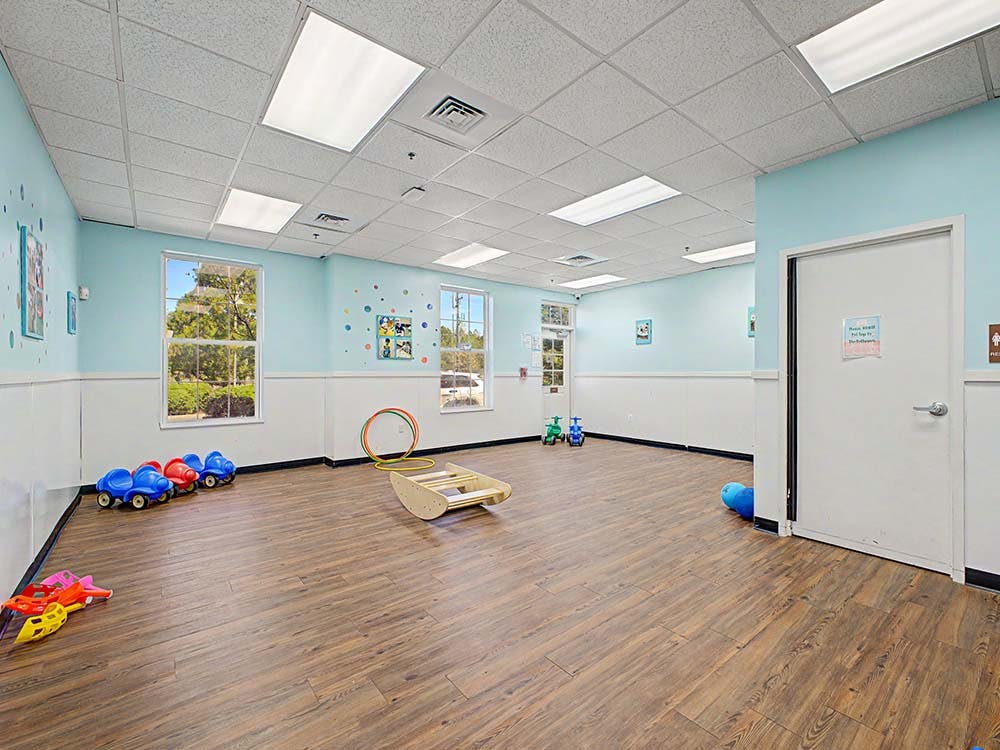 Empty children's play room with toys on the floor