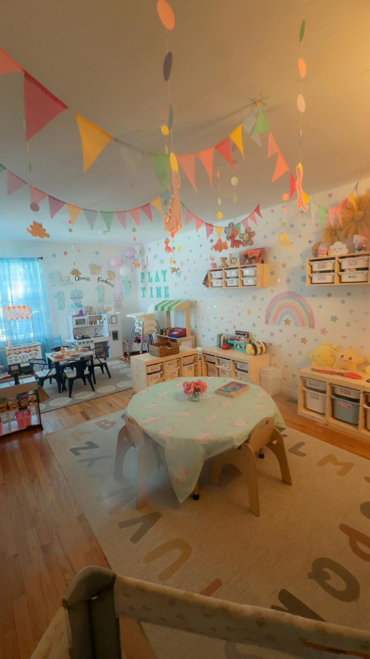Playroom with tables and chairs for children and colorful wall decorations