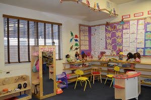 Empty classroom with small chairs and educational posters