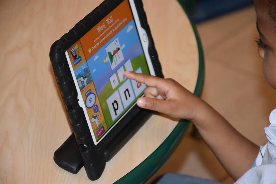 Child using a tablet with an educational game