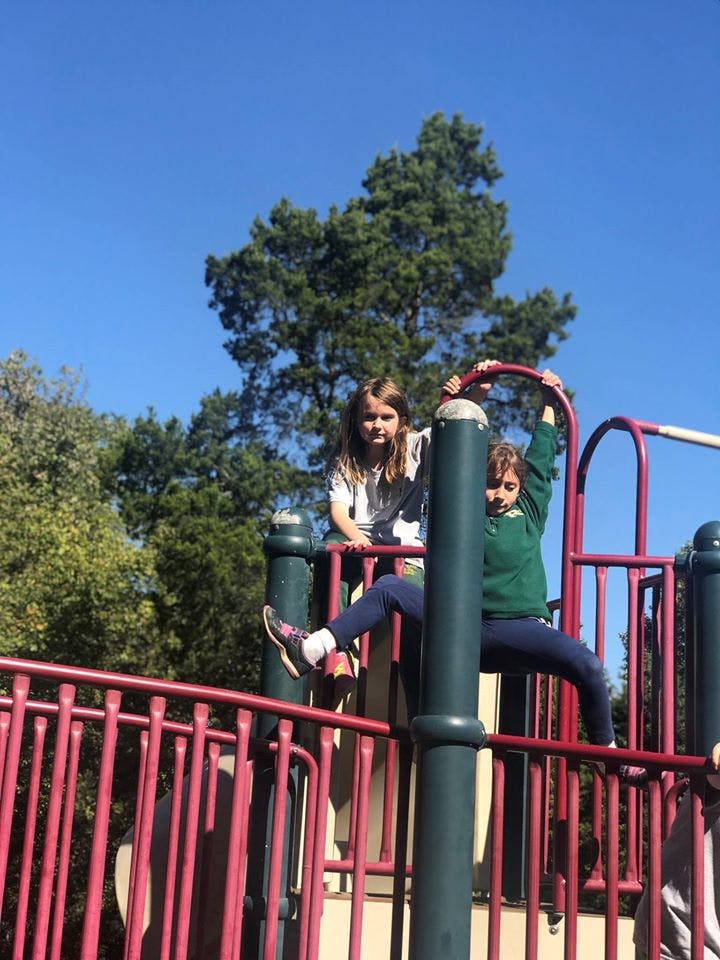 Two children on a playground structure