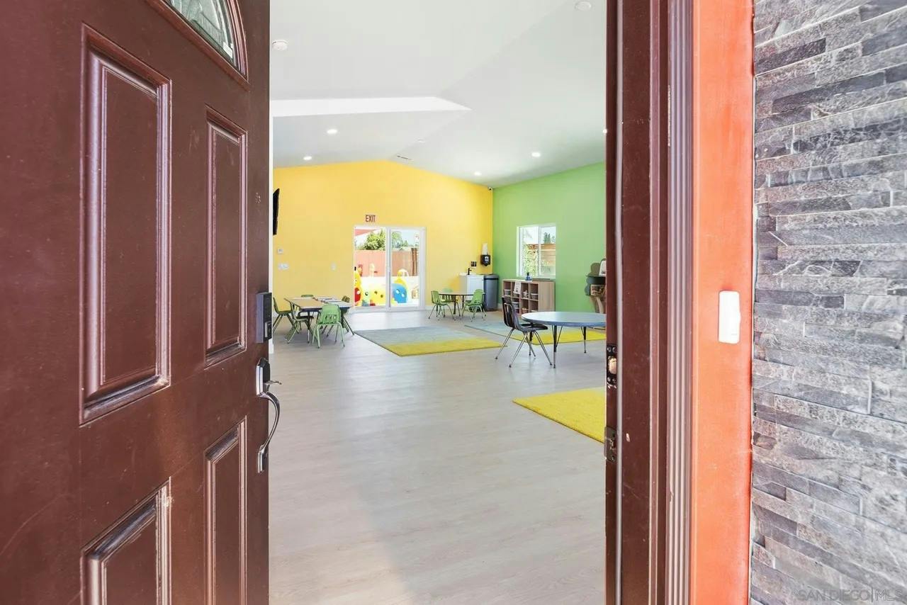 Spacious daycare classroom with small tables and chairs