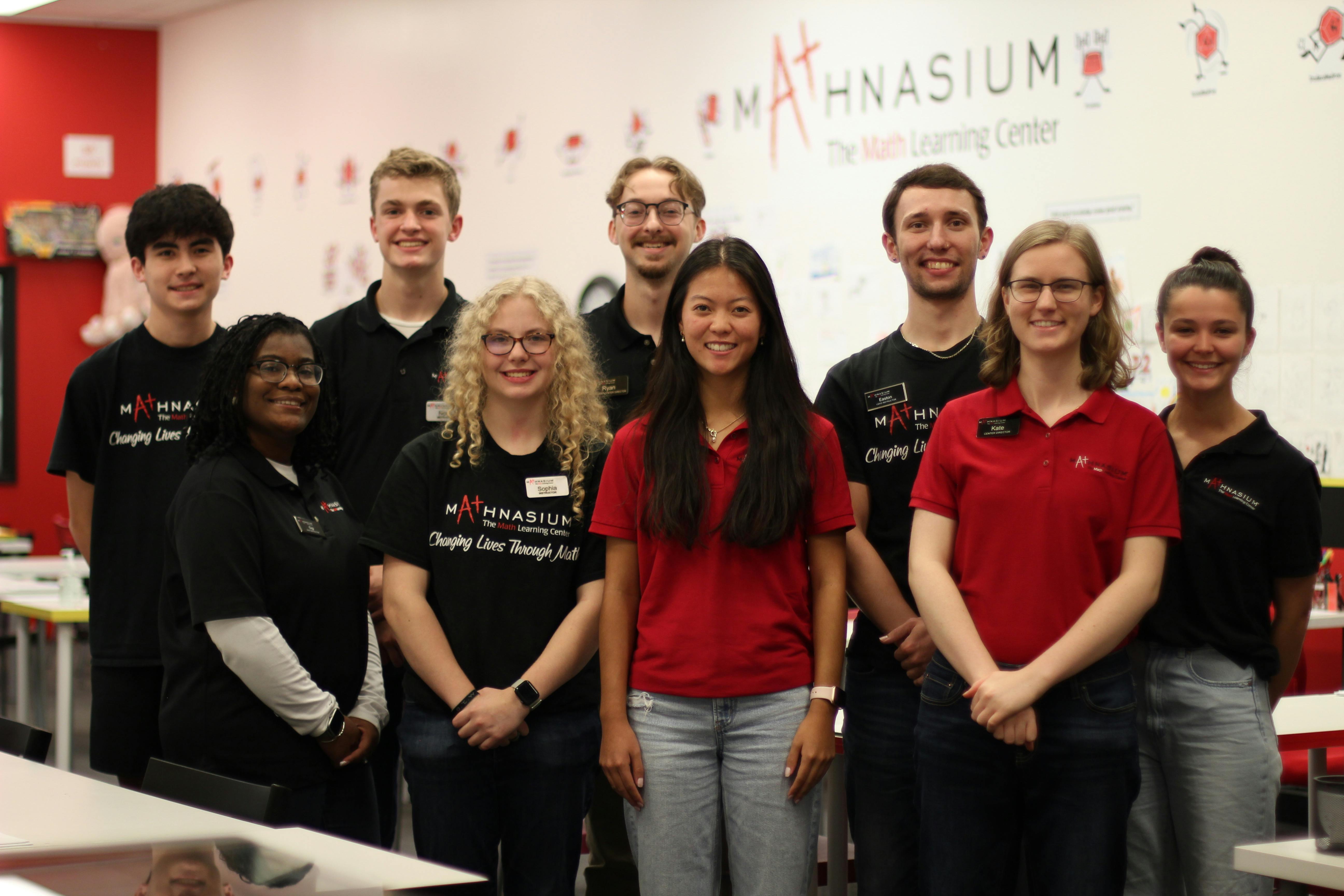 Group of people standing in front of a Mathnasium sign