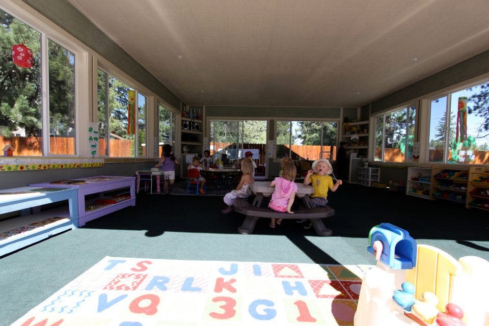 Children sitting at a table in a classroom