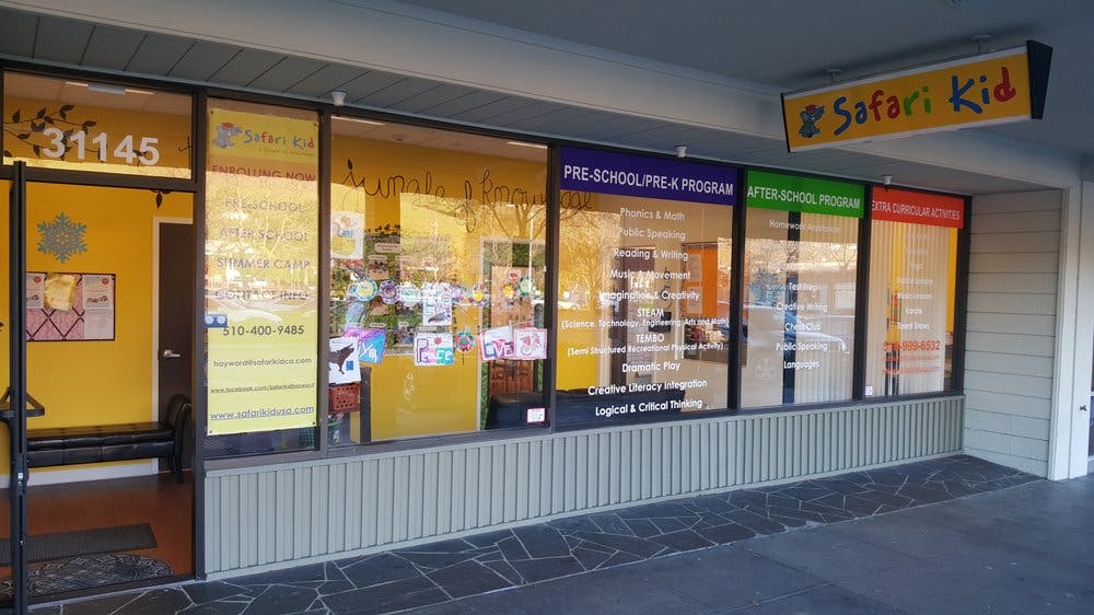 Storefront with "Safari Kid" sign and window displays