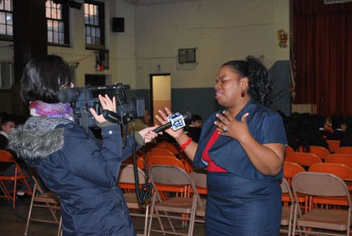 Person holding a microphone to another person speaking