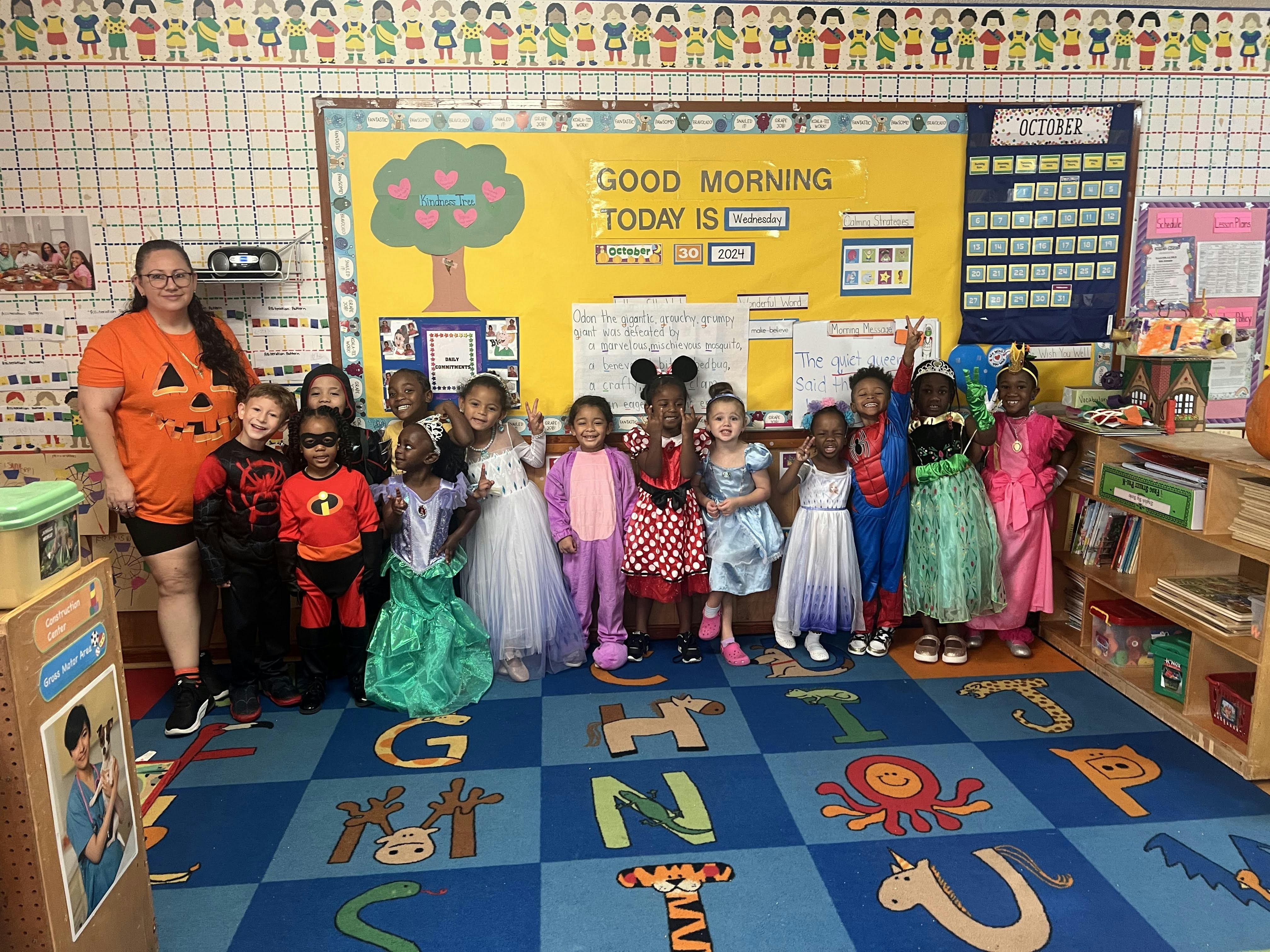 Adult and children in costumes in a classroom