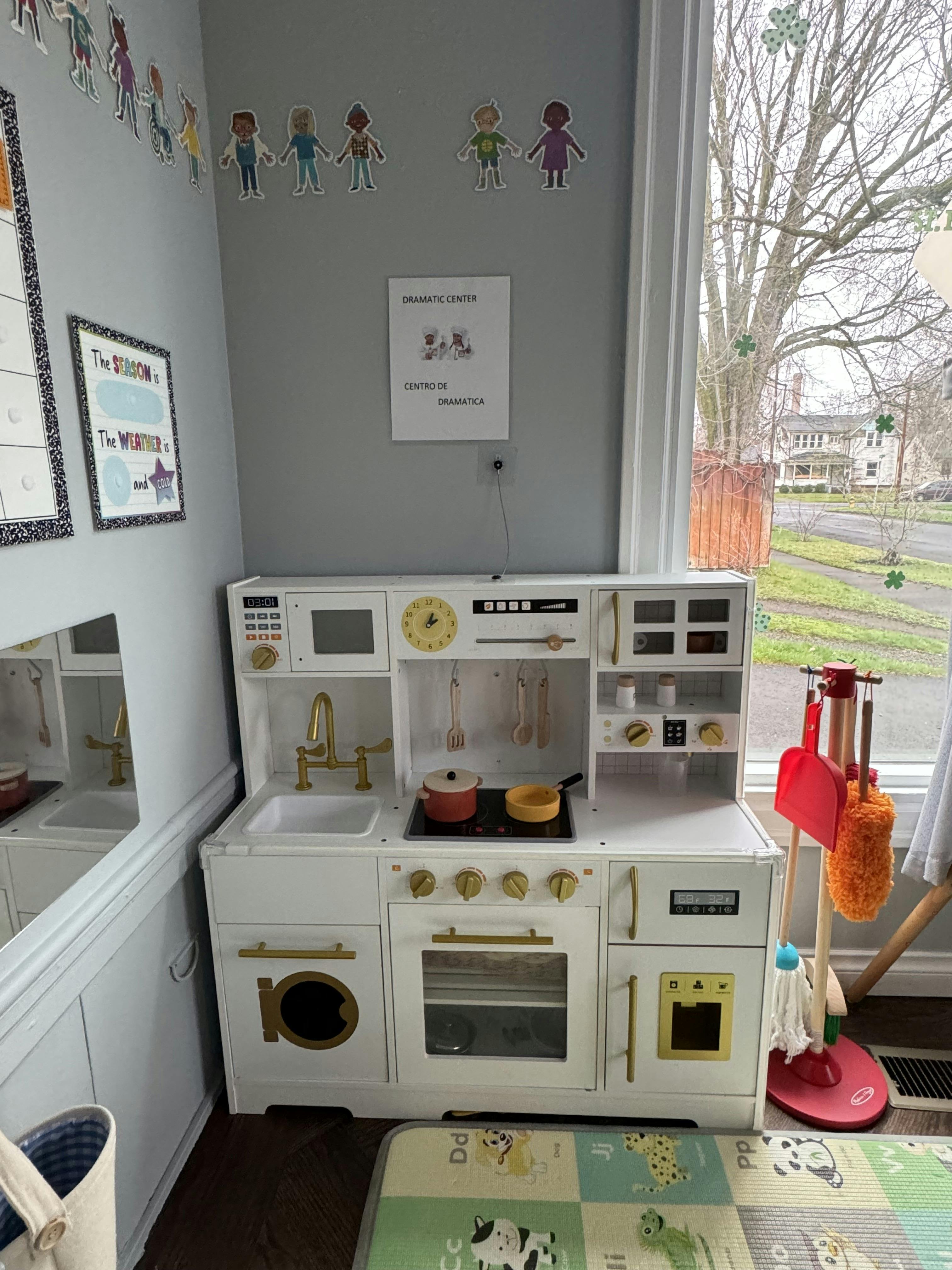 Child-sized play kitchen set with a sink, stove, oven, and microwave