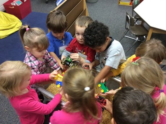 Children playing with toys in a classroom