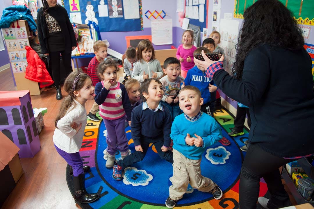 Adults and children gathered in a classroom