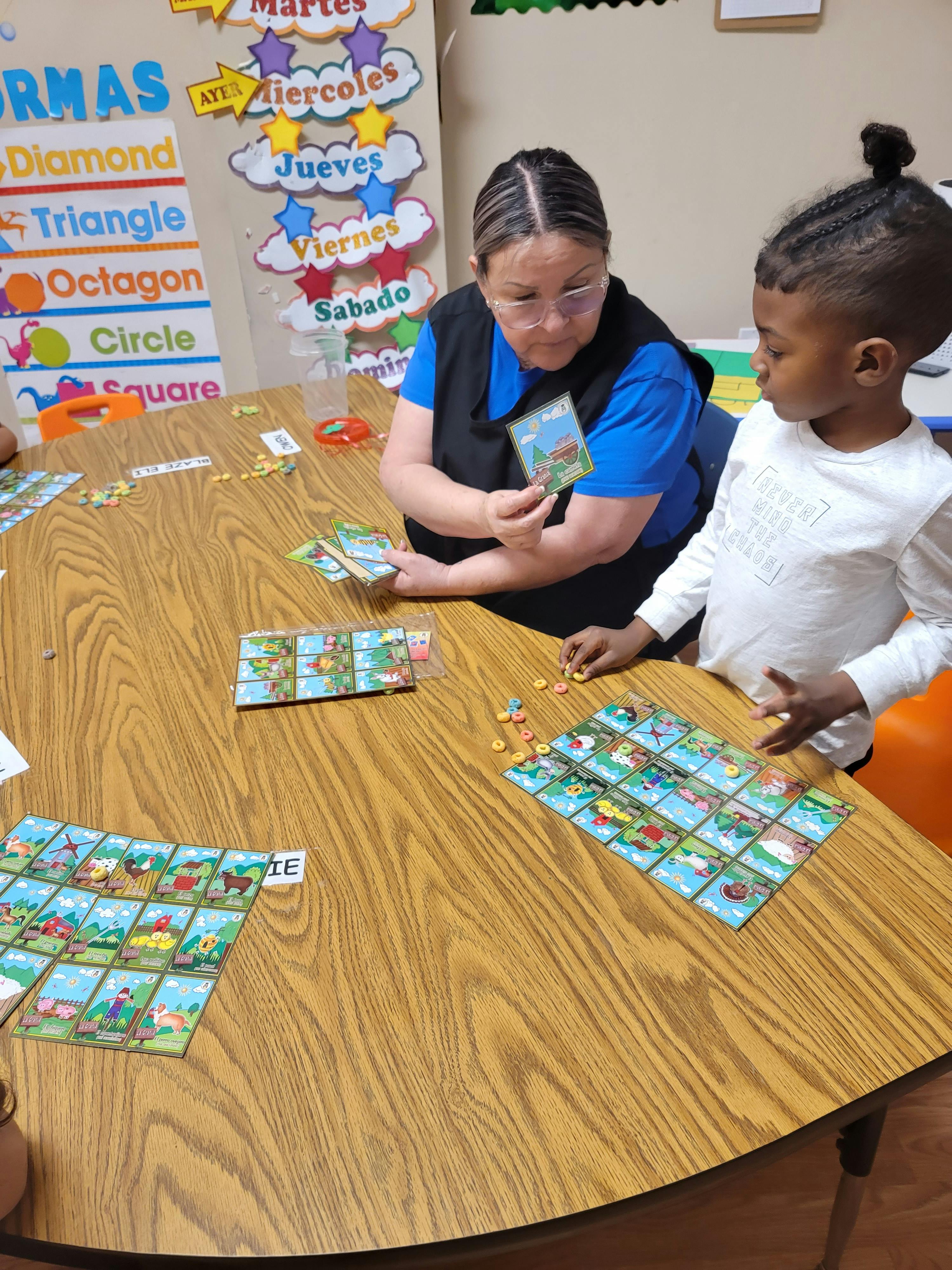 Adult and child playing a board game at a table