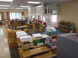 Classroom with wooden shelves and a small loft area