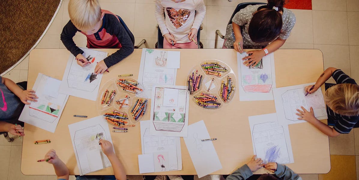 Children drawing at a table