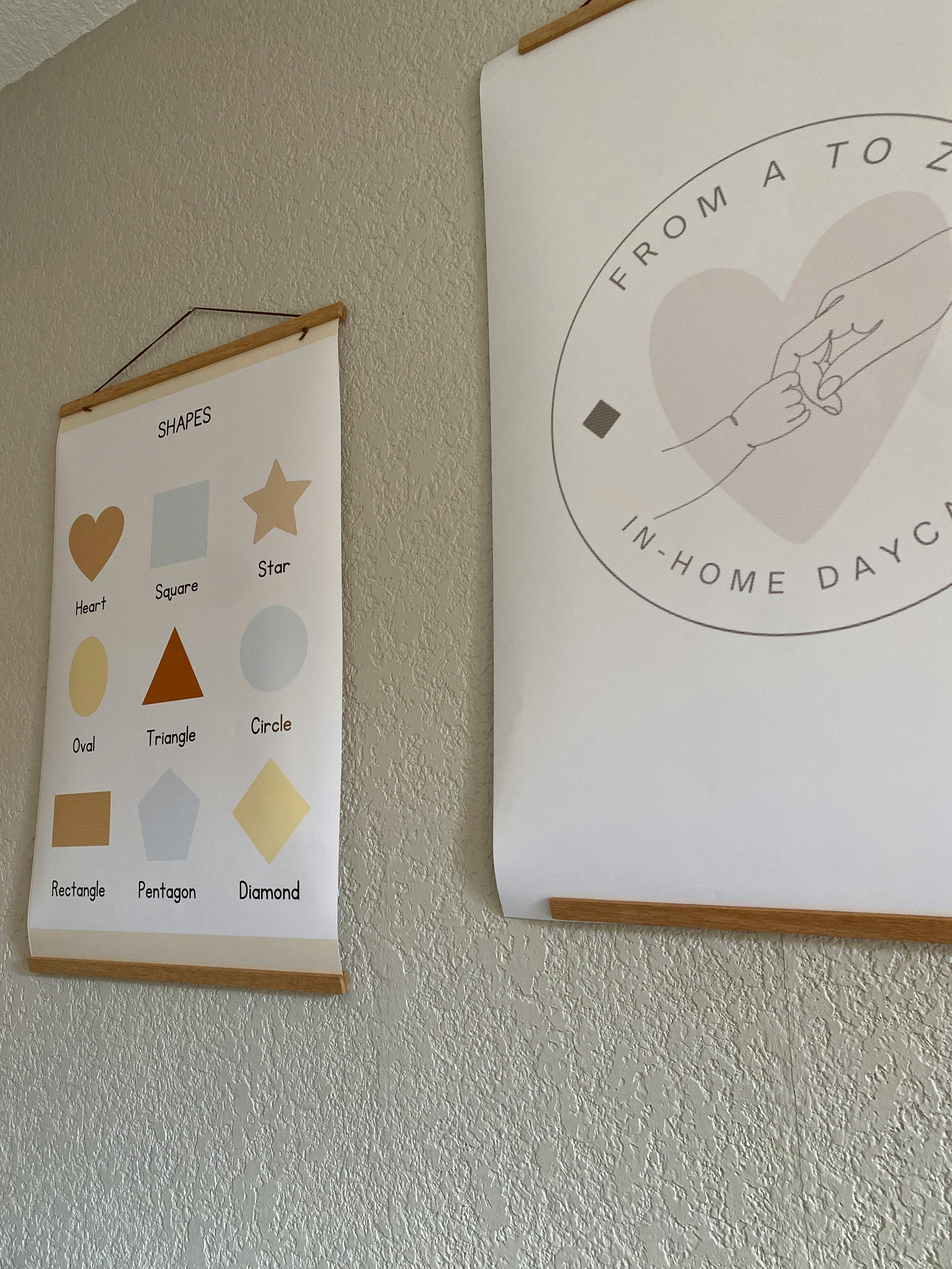 Two educational posters hanging on a wall, one with shapes and one with text