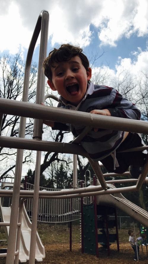 Child on playground climbing structure
