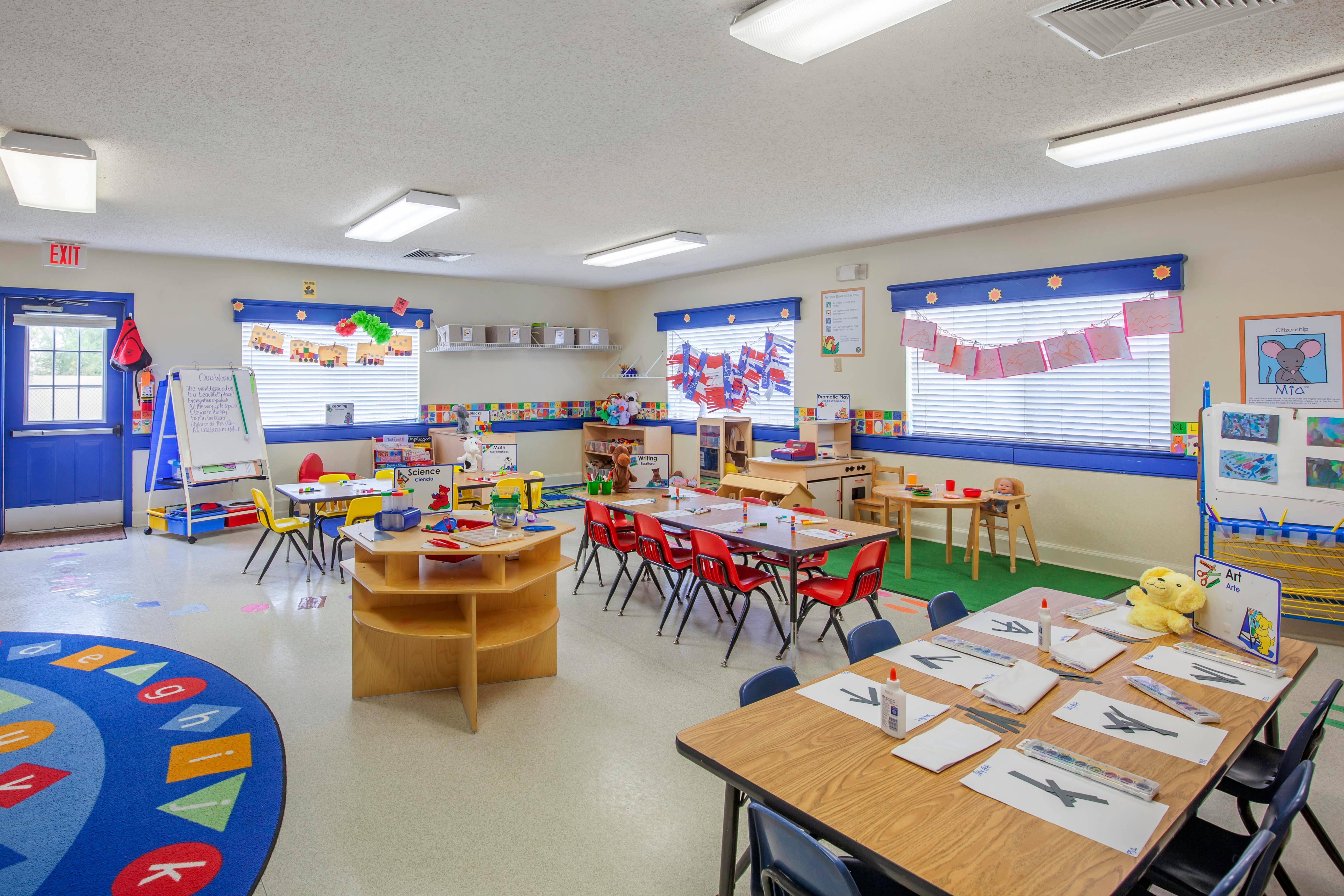An empty colorful classroom with small tables and chairs
