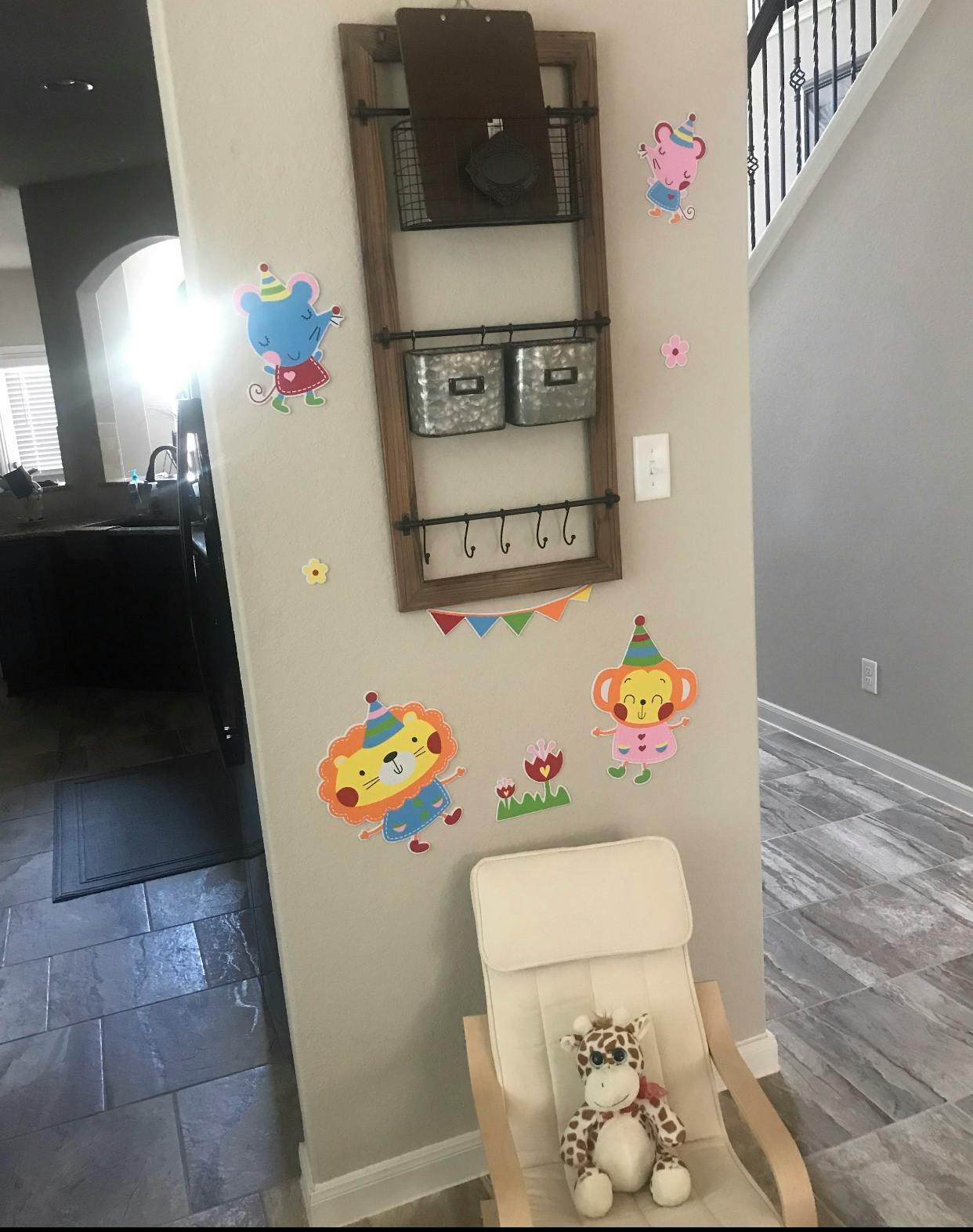 Wall decorated with cartoon animal cutouts and a wooden organizer