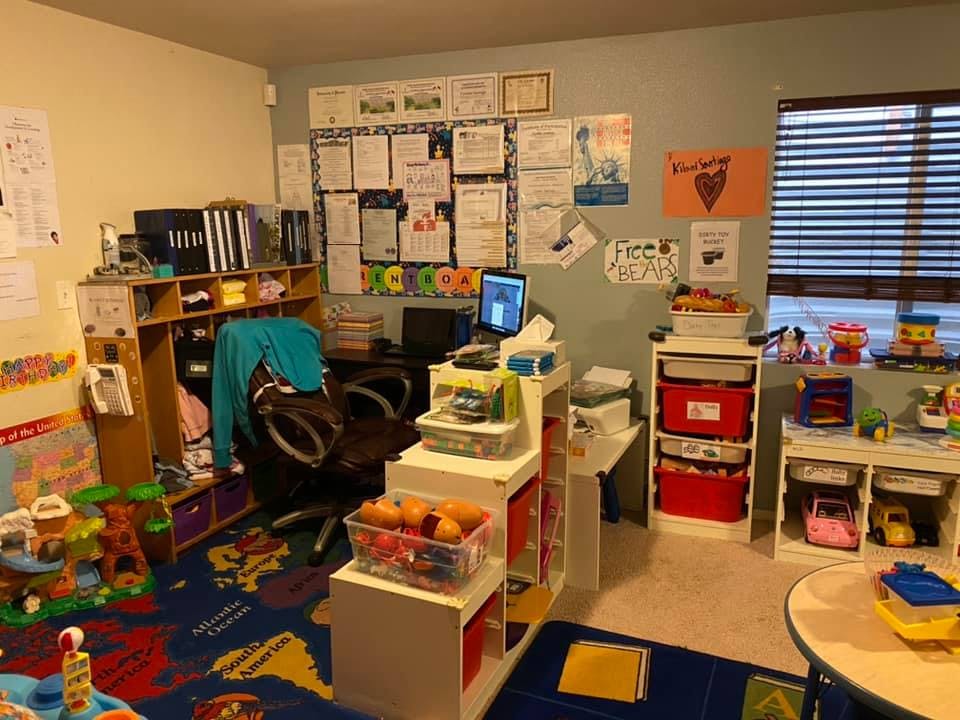Home office with a desk, computer, and children's toys