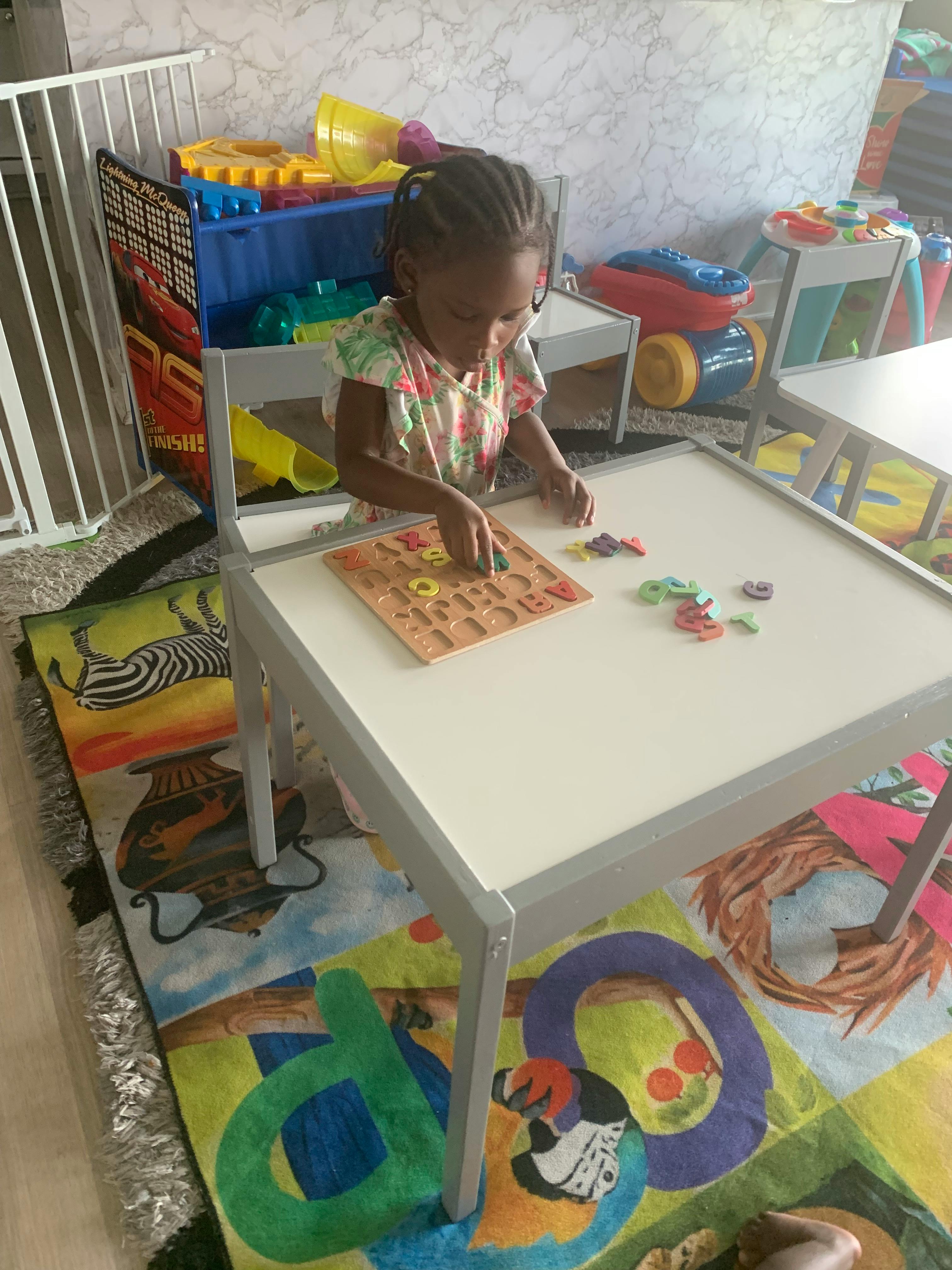 Child playing with a puzzle at a table