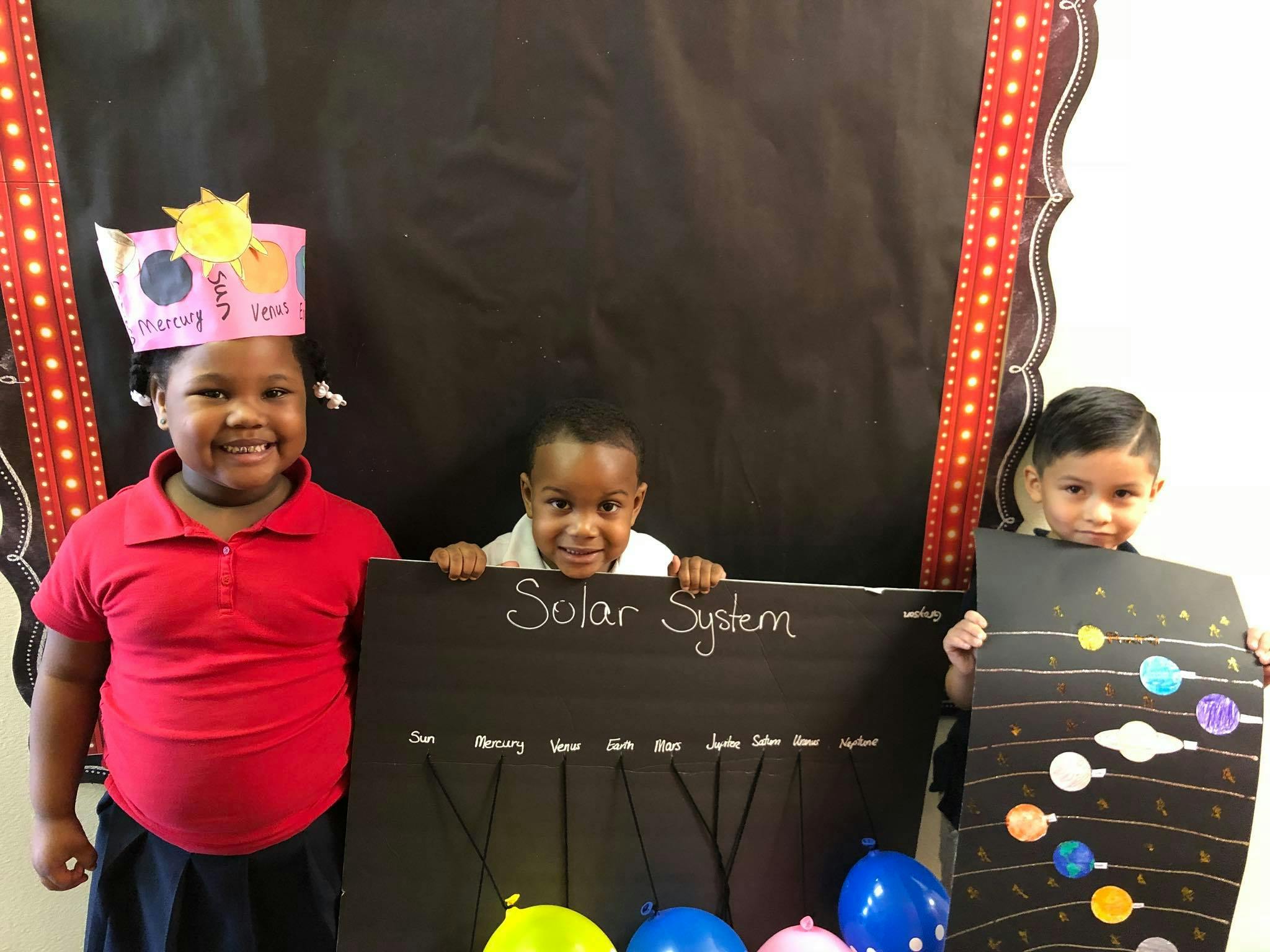 Three children with solar system projects