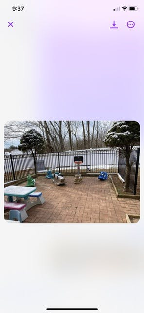 Outdoor play area with a picnic table and various toys on-ground toys