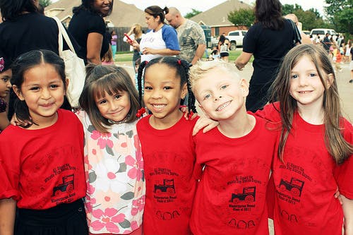 Five children in red shirts standing together