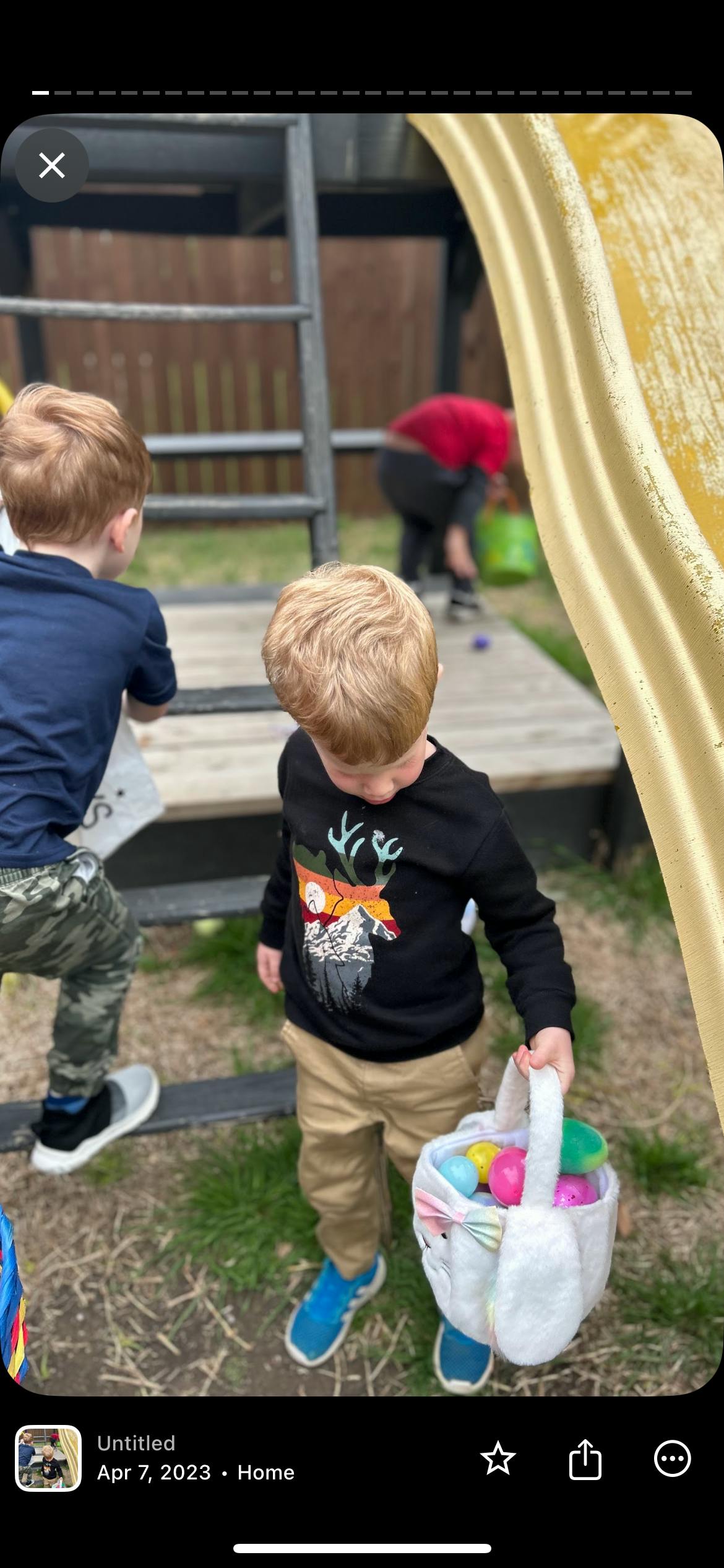 Child holding an Easter basket filled with eggs
