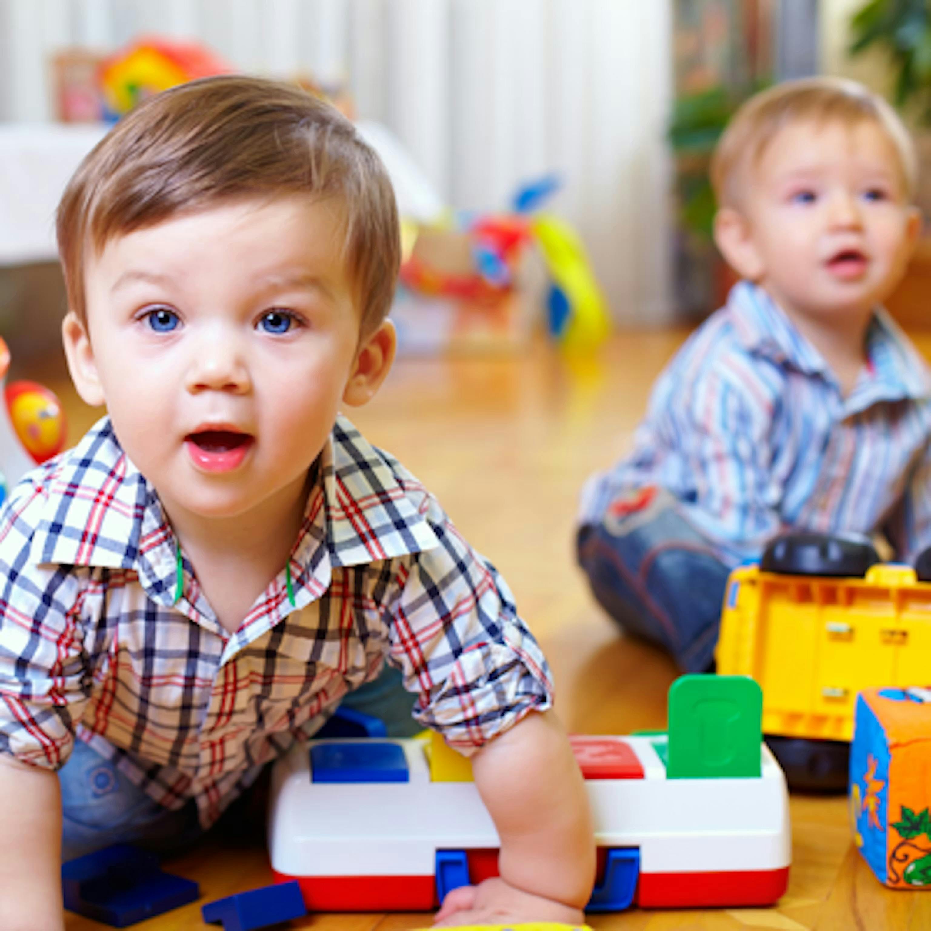 Two children playing with toys on the floor