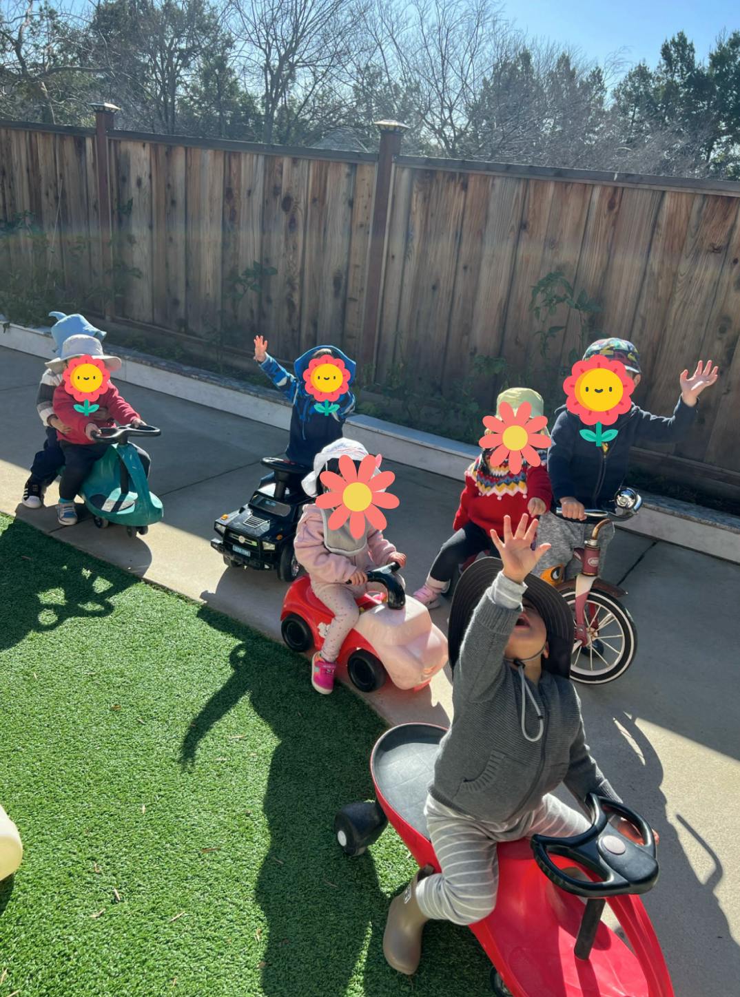 Children riding toy vehicles outdoors