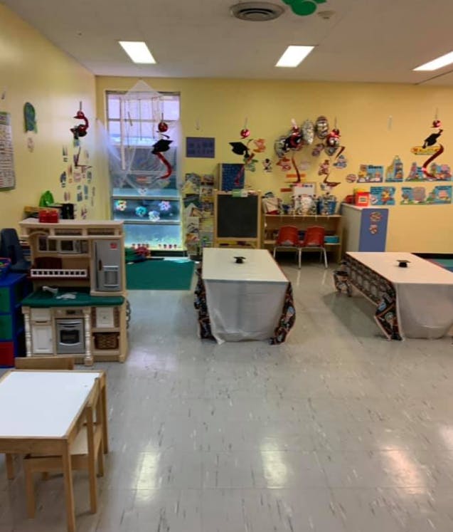 Classroom with play kitchen, tables, and decorations