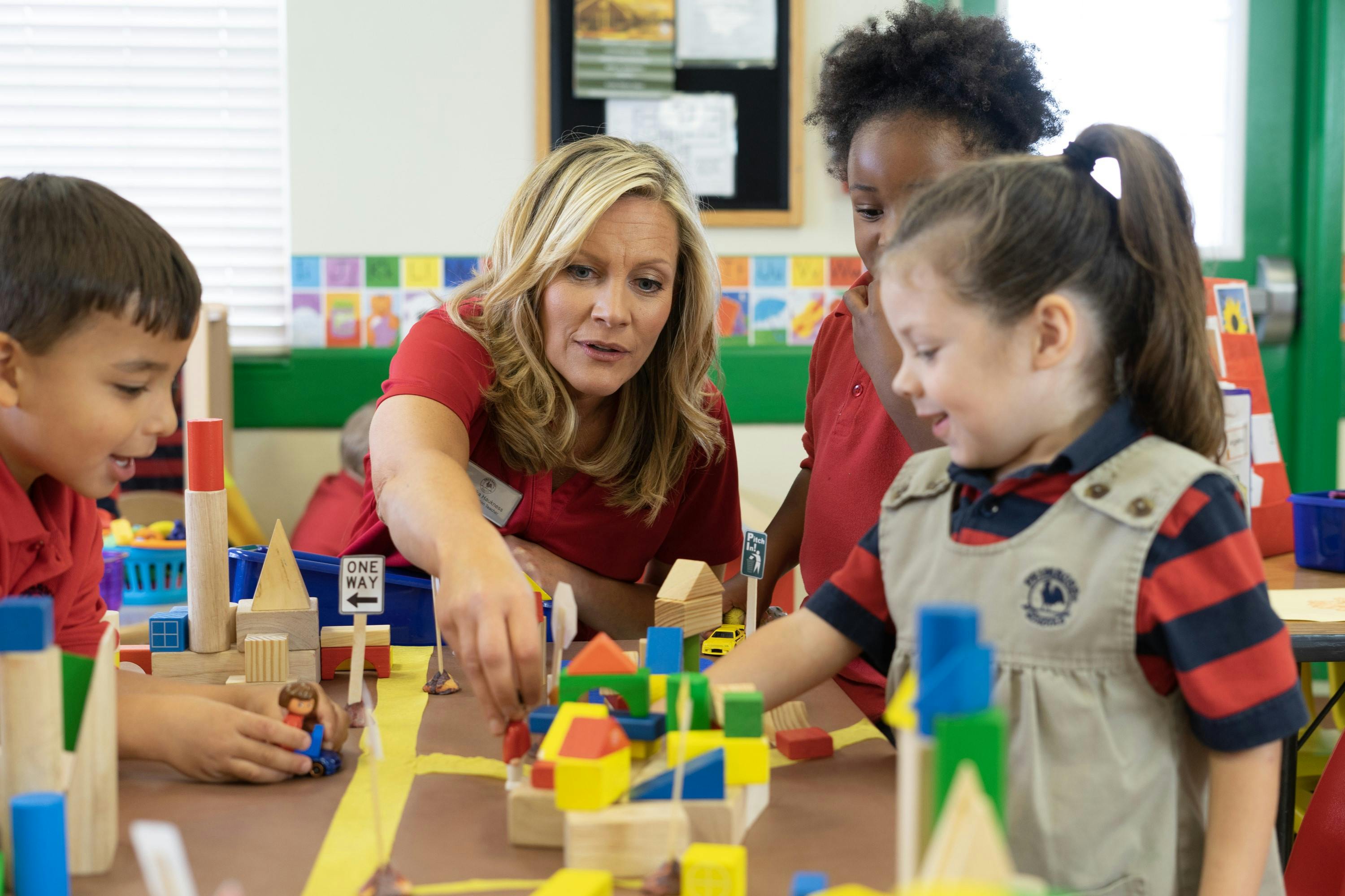 Adults and children playing with building blocks