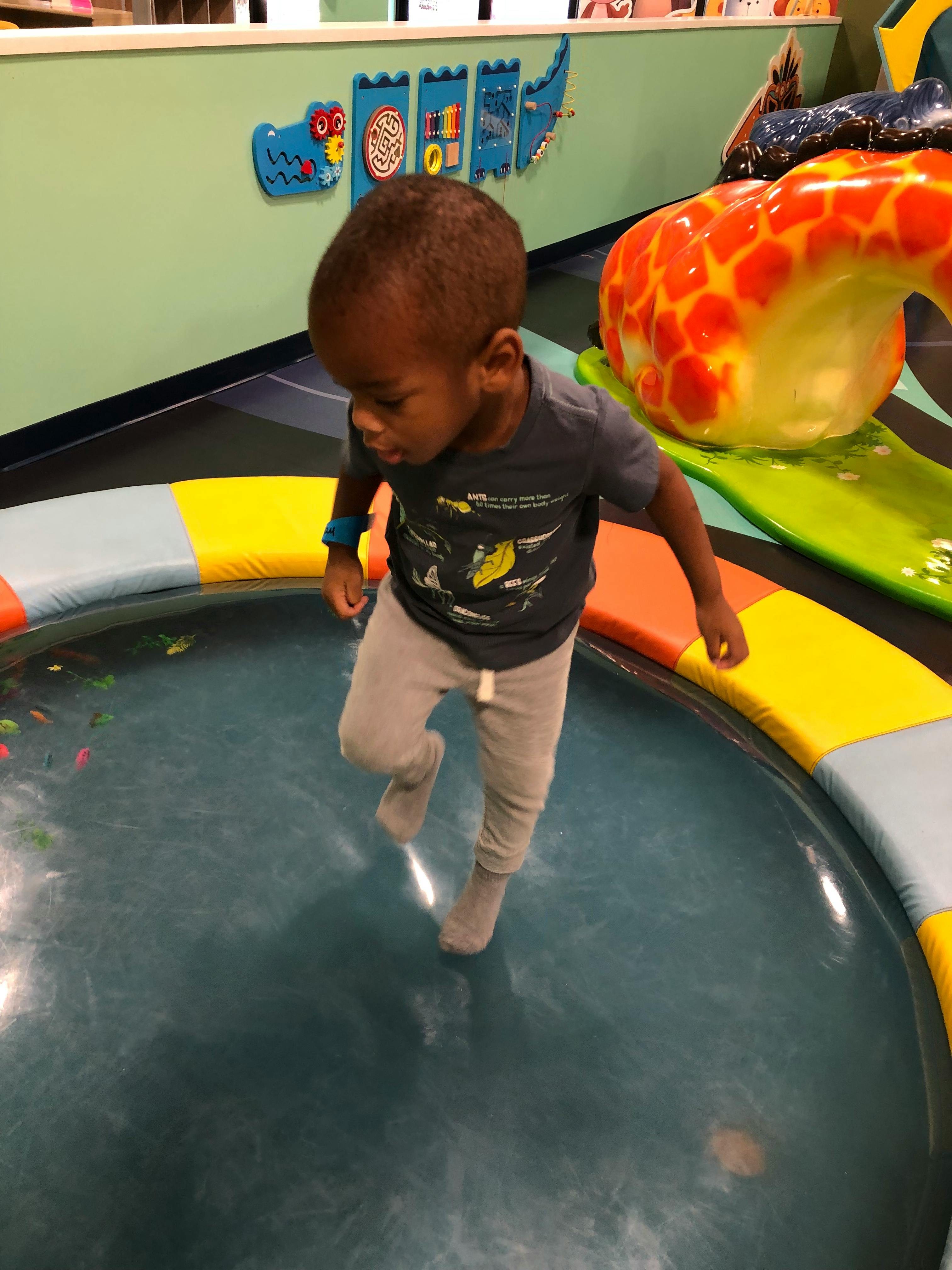 Child walking on a soft play surface in an indoor play area