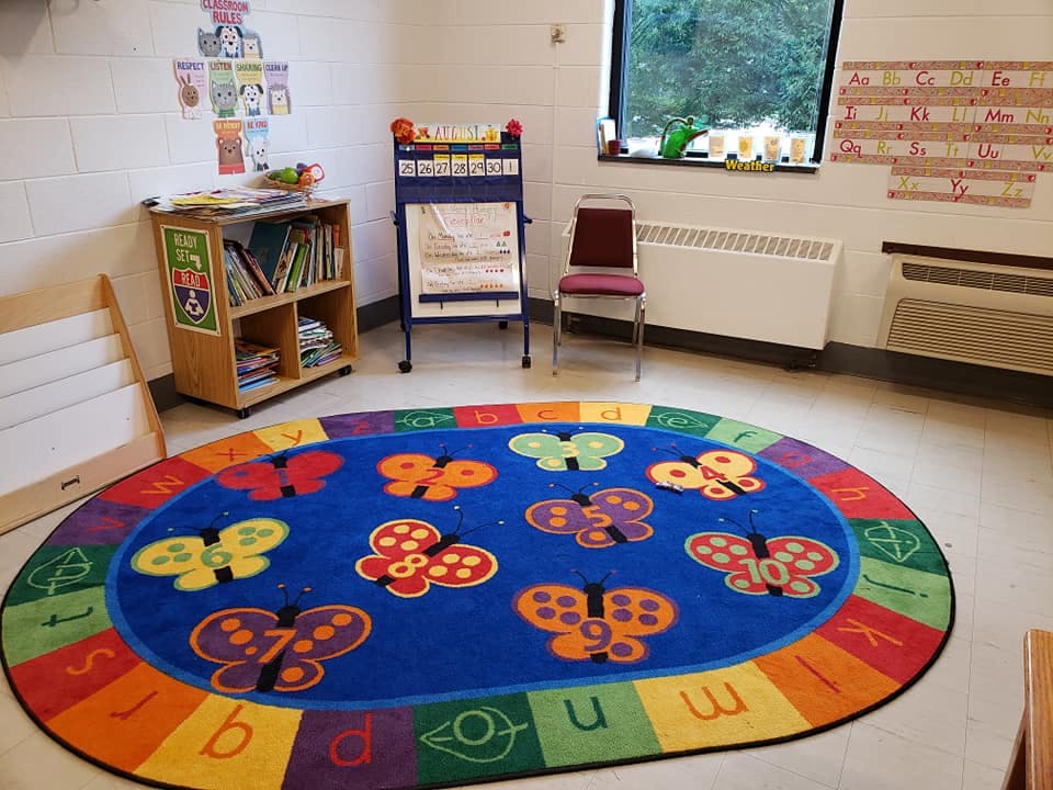 Classroom with a colorful butterfly and alphabet rug