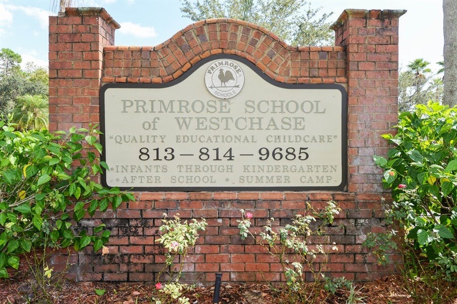 Brick sign for Primrose School of Westchase with phone number