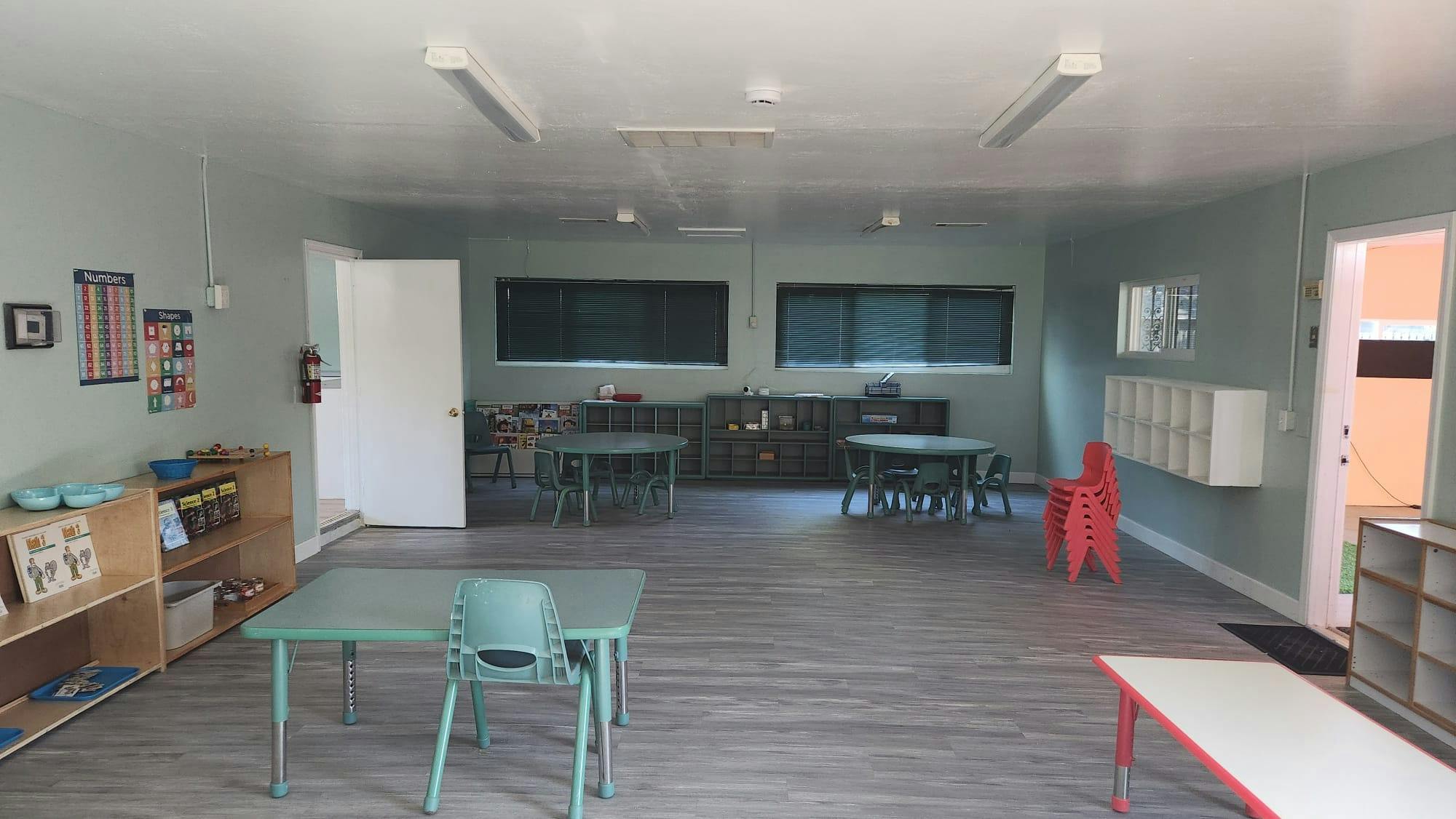 Empty classroom with small tables and chairs