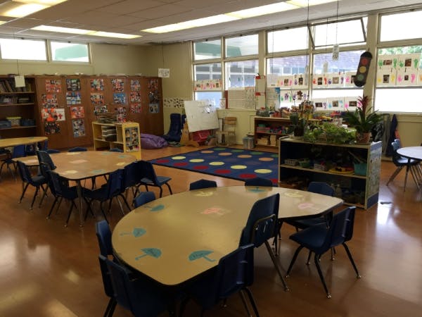 Empty classroom with small tables and chairs
