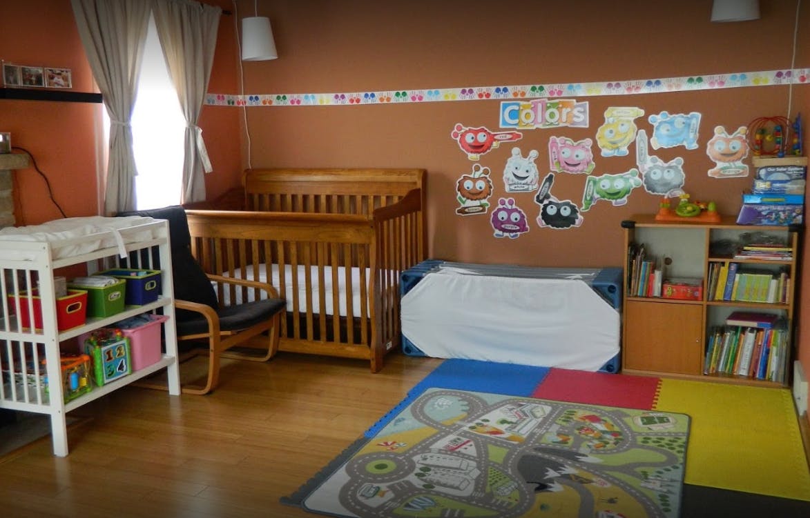 Nursery room with crib, changing table, and colorful decorations