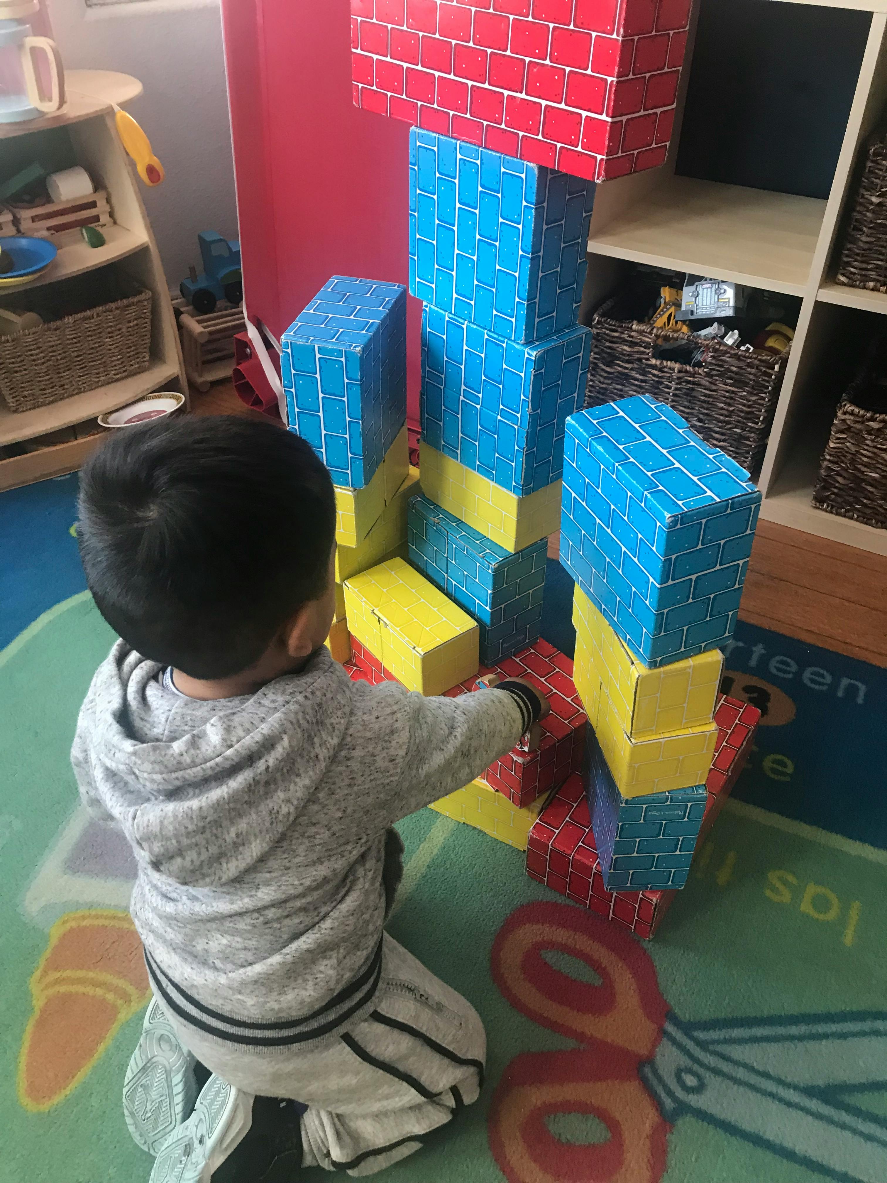 Child playing with large building blocks