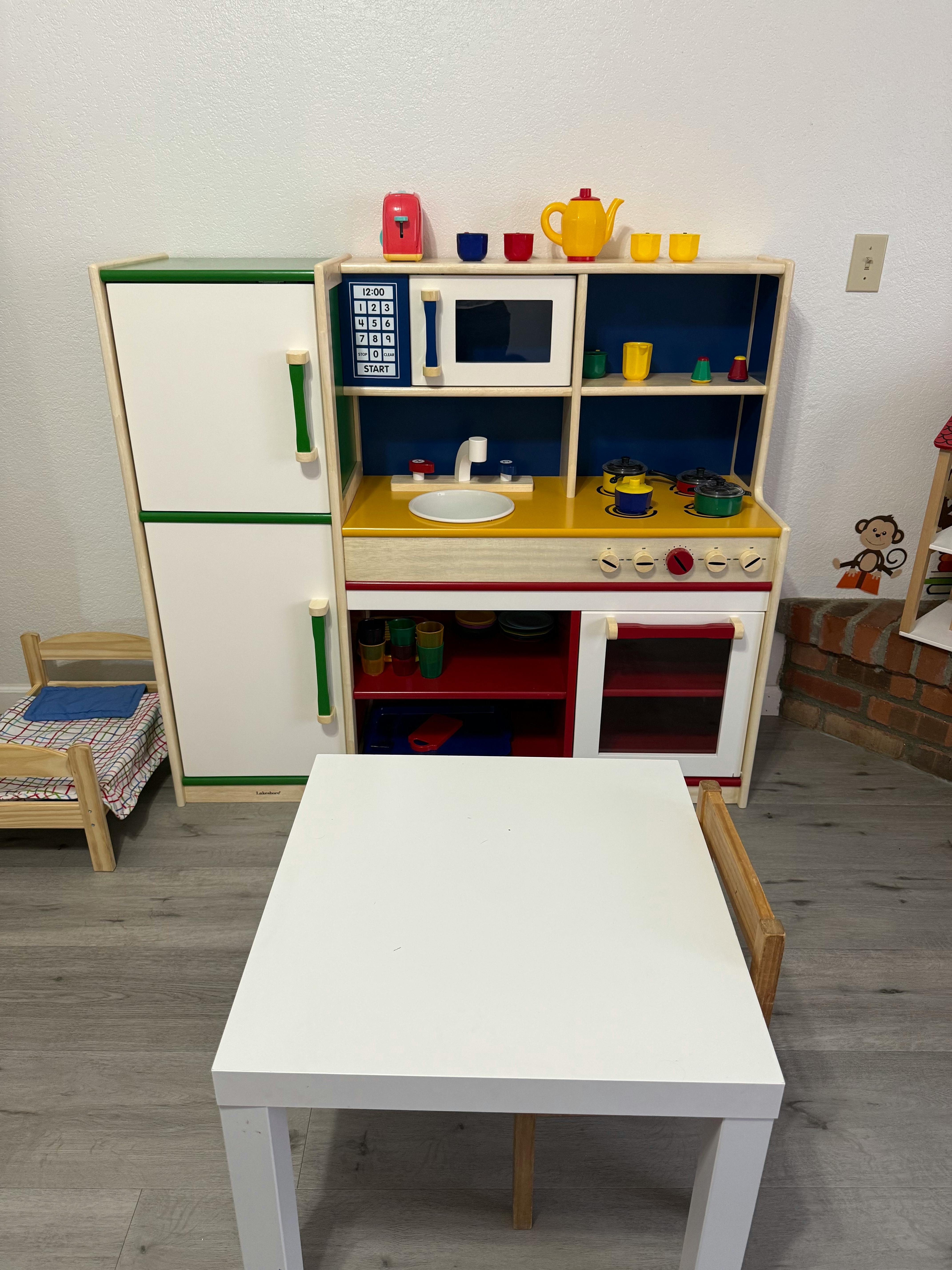 Play kitchen set with a white table in the foreground