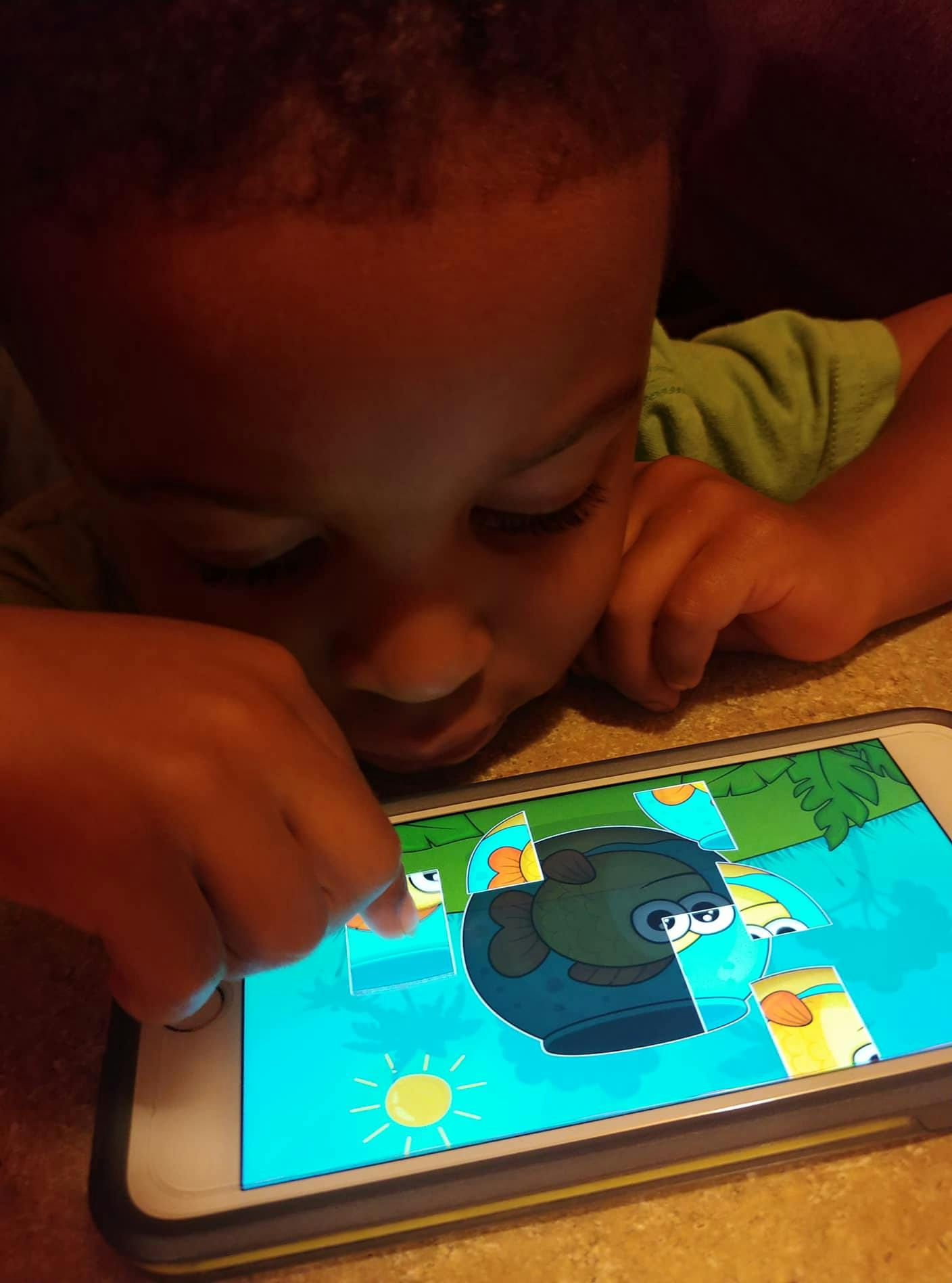 Child playing a puzzle game on a smartphone