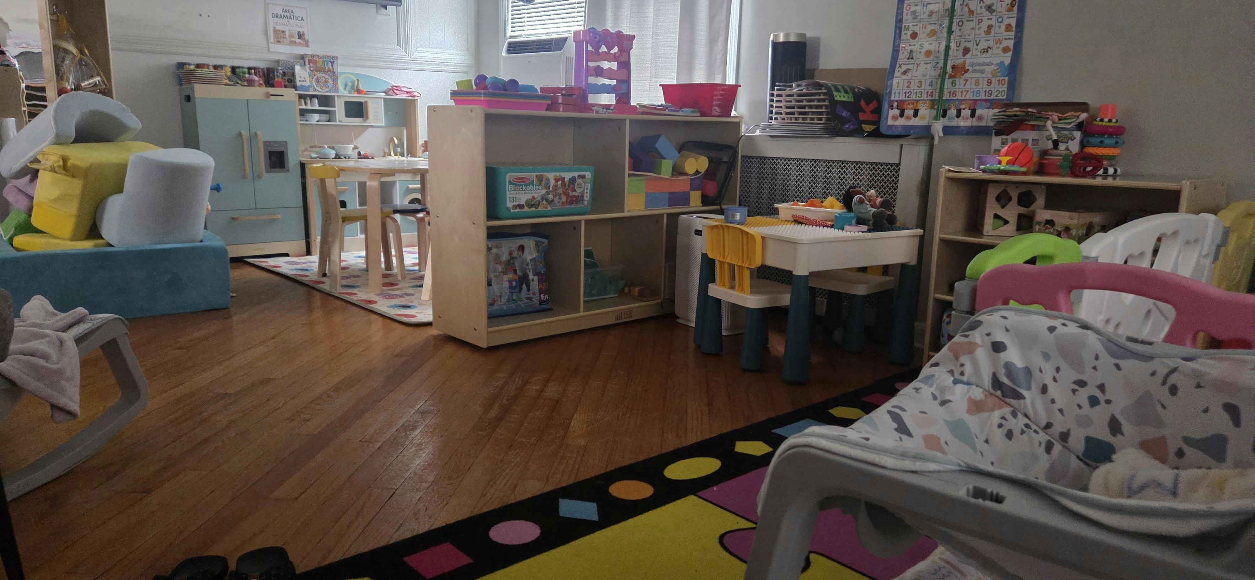 Playroom filled with children furniture toys and activity mats