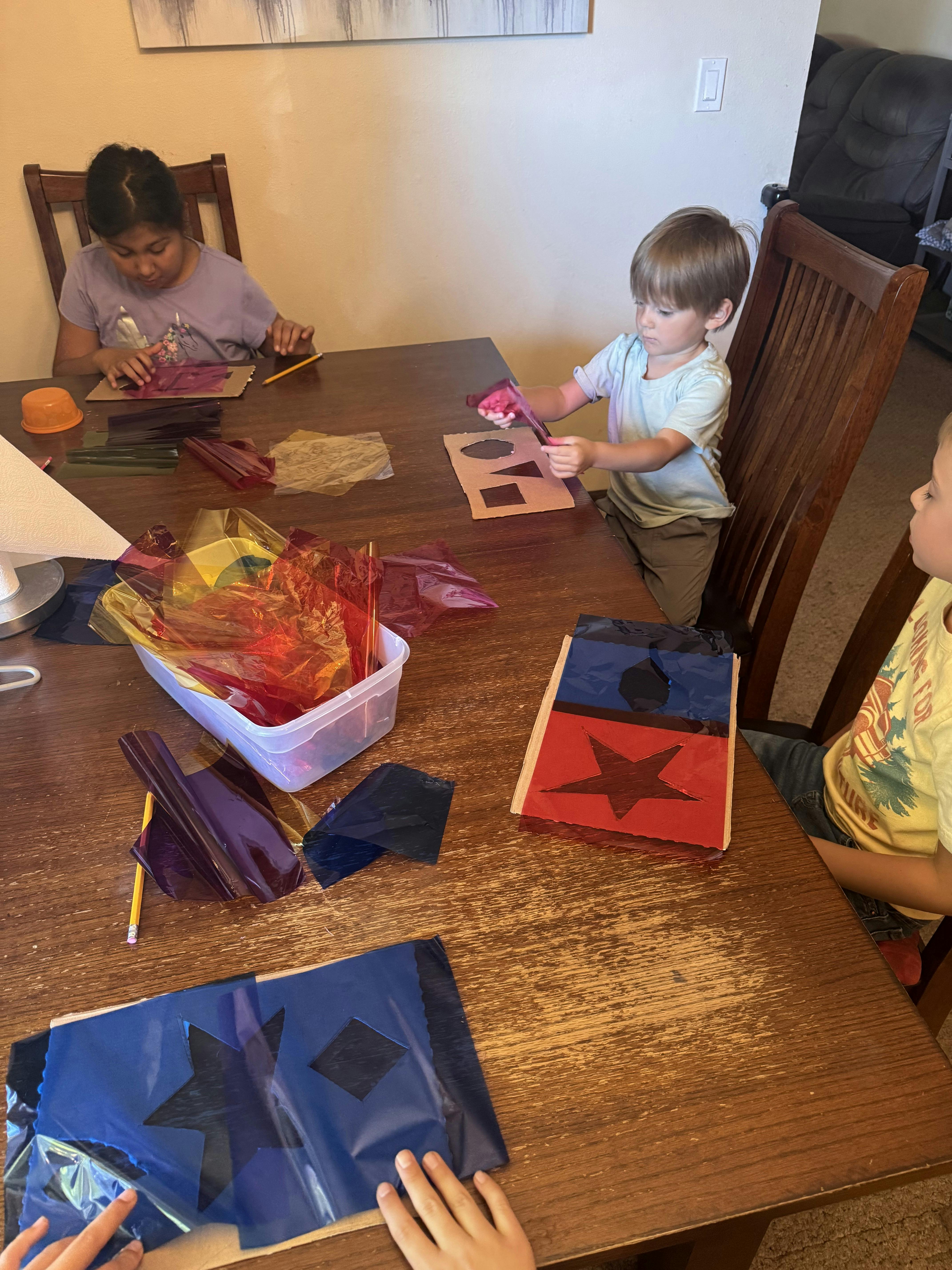 Three children doing crafts at a table