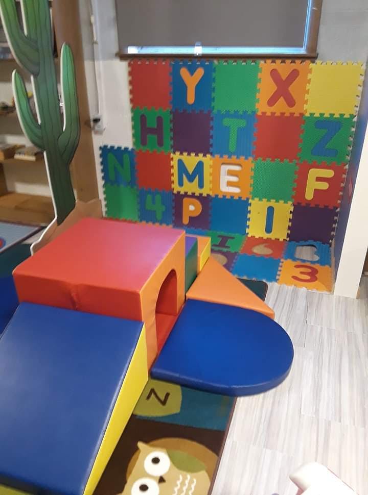 Soft play equipment and alphabet floor mats in a play area