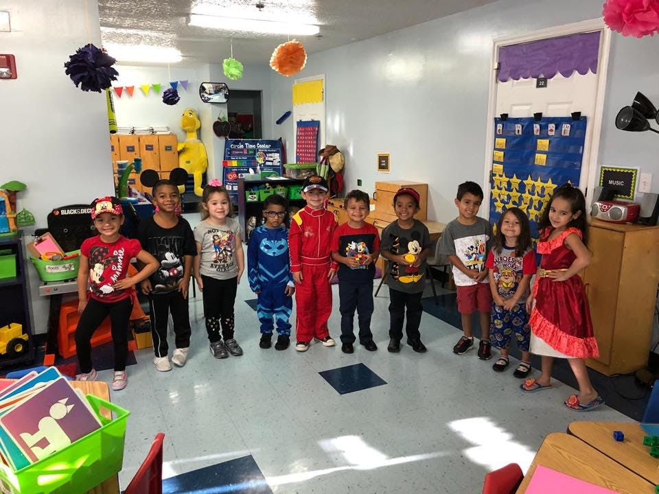 Group of children standing in a classroom
