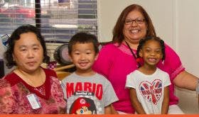 Two adults and two children posing for a photo