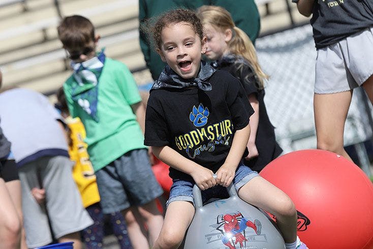 Child on a gray hopper ball with a Spider-Man design