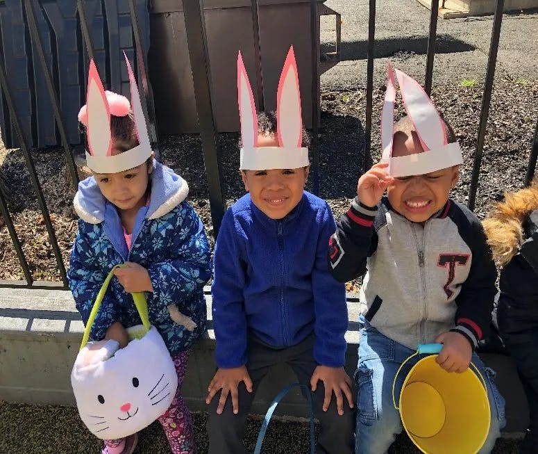 Three children wearing bunny ear headbands