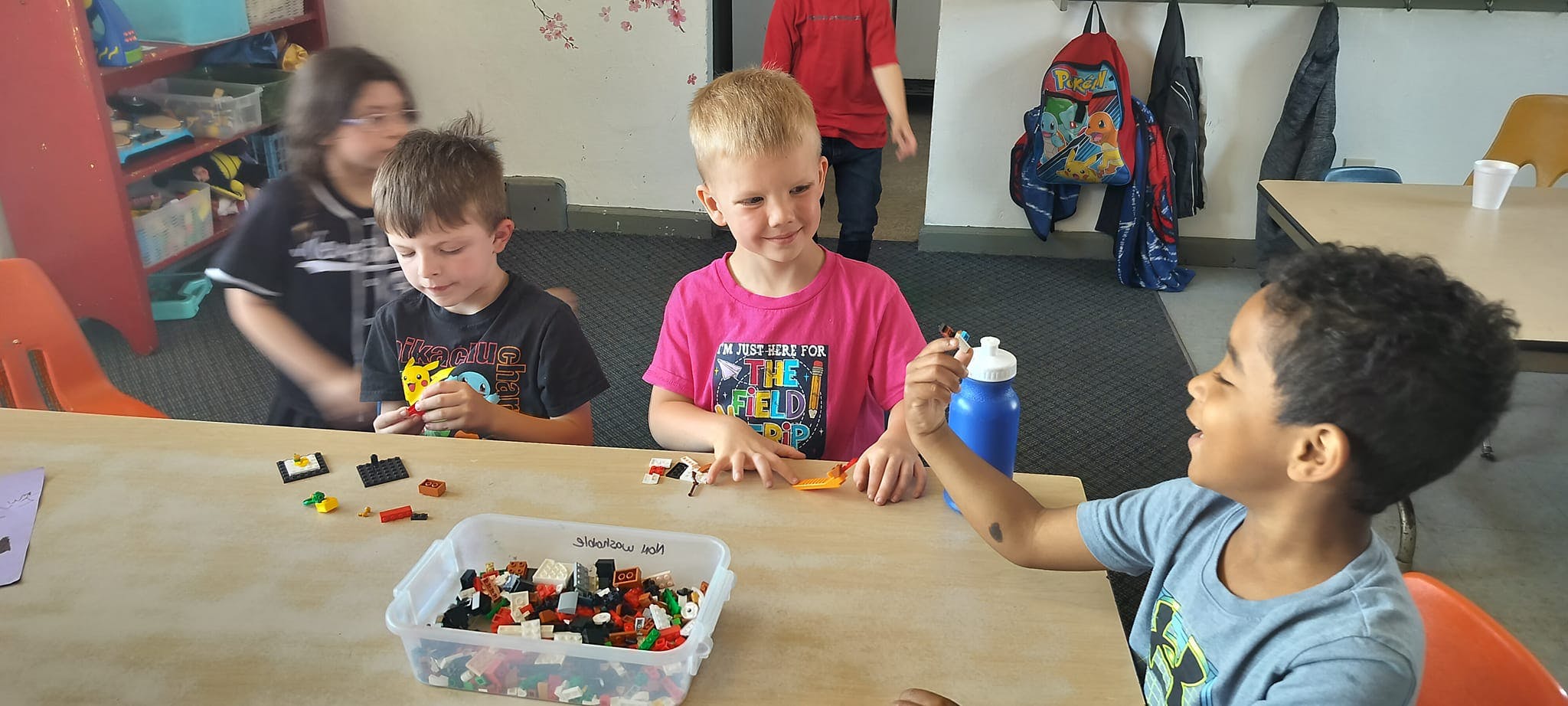 Children playing with building blocks at a table