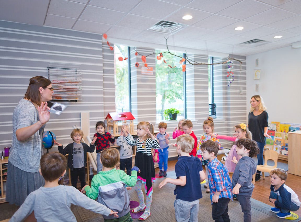 Adults and children in a classroom