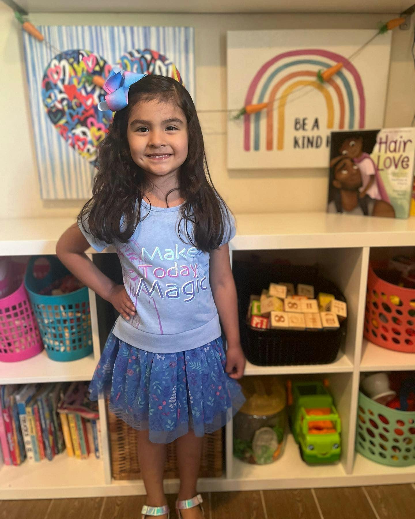 Child standing in front of shelves with toys and books